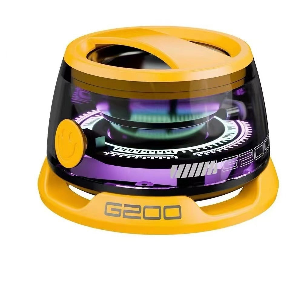 A portable Bluetooth speaker with RGB lighting, displayed in a transparent case, showing internal components and a magnetic phone holder.