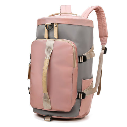 A pink and gray shoulder sports bag with multiple compartments and adjustable straps.