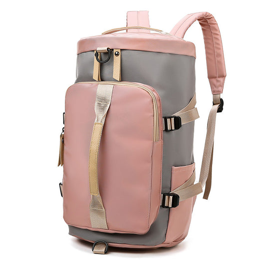 A pink and gray shoulder sports bag with multiple compartments and adjustable straps.
