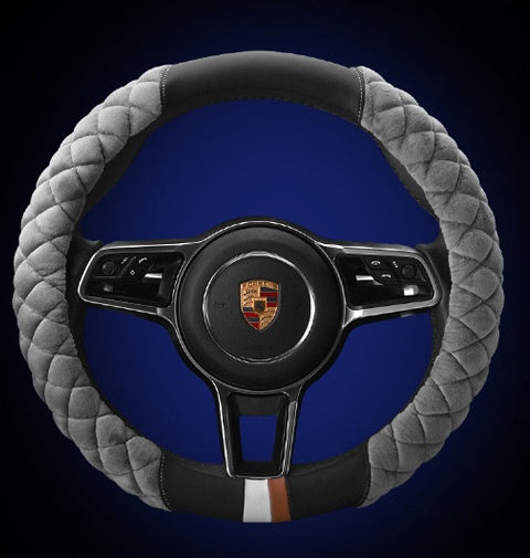 Steering wheel with gray quilted cover and blue background