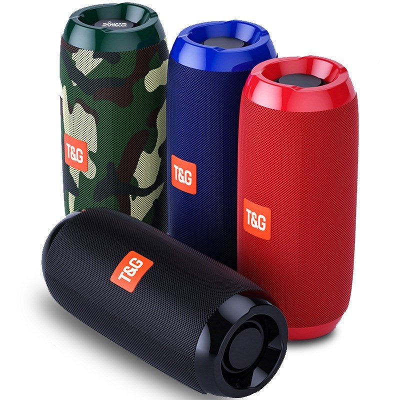 A collection of four portable Bluetooth speakers in different colors: camouflage pattern, blue, red, and black.