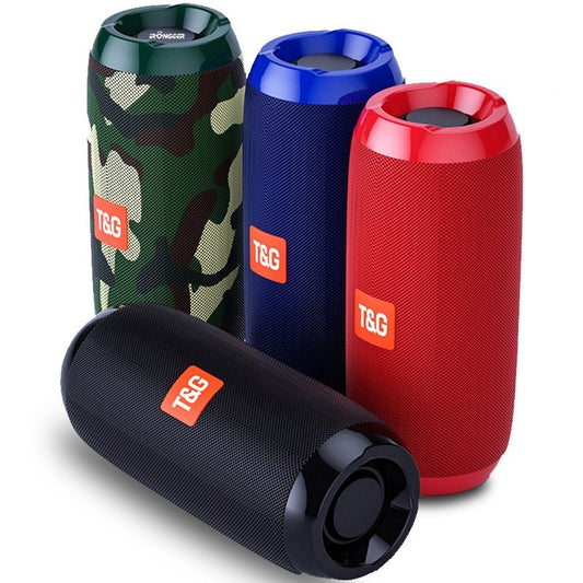 A collection of four portable Bluetooth speakers in different colors: camouflage pattern, blue, red, and black.