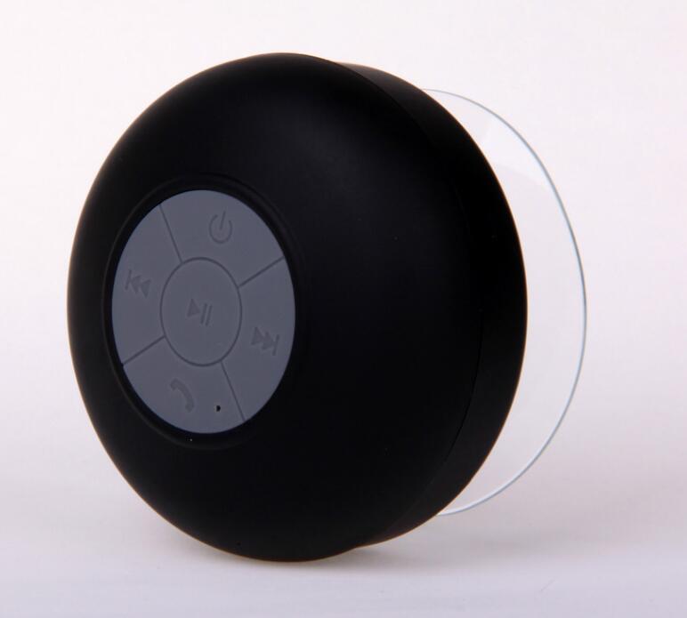A black mini waterproof Bluetooth speaker with a suction cup and control buttons on the top.