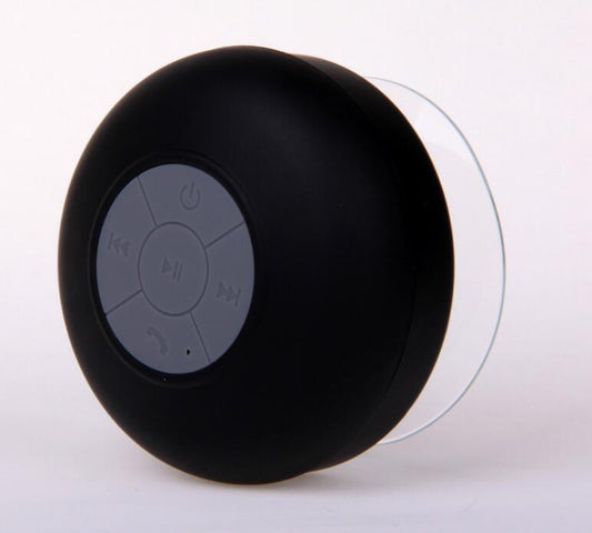 A black mini waterproof Bluetooth speaker with a suction cup and control buttons on the top.