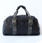 A pink and gray nylon yoga bag with a shoulder strap and a silhouette of a yoga pose on the front.