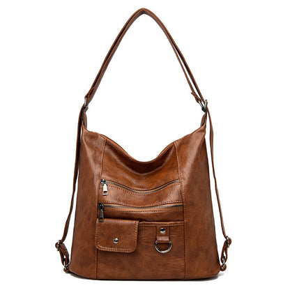 A brown soft leather diagonal shoulder bag with a zipper closure and double roots.