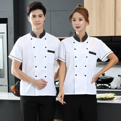 A male and a female chef wearing white short-sleeve chef uniforms with black accents in a kitchen setting.