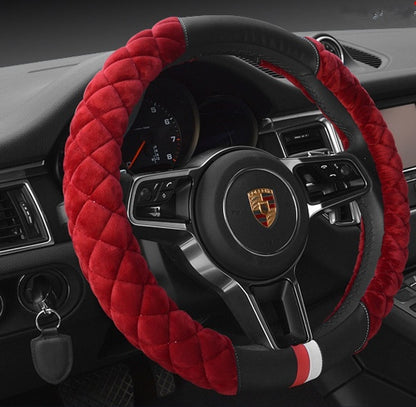Steering wheel cover with red quilted design on a car dashboard.