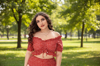 A woman wearing a red and white polka dot split bikini top with off-the-shoulder sleeves and matching bottoms.