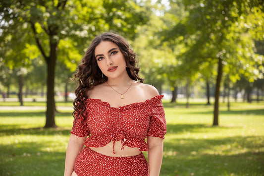 A woman wearing a red and white polka dot split bikini top with off-the-shoulder sleeves and matching bottoms.