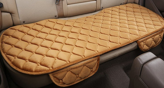 A beige, plush, non-slip car seat cover with cotton filling, designed for use in automotive vehicles, particularly during autumn and winter seasons.