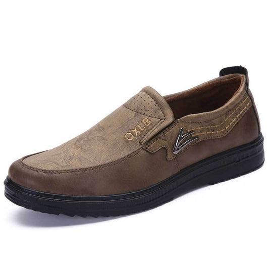 A pair of brown casual men's shoes with a low heel and round toe style.