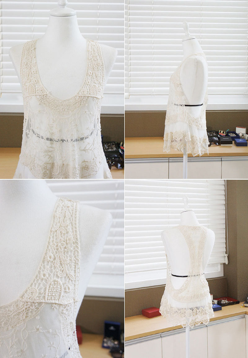 White lace dress on a mannequin in a room with window blinds.