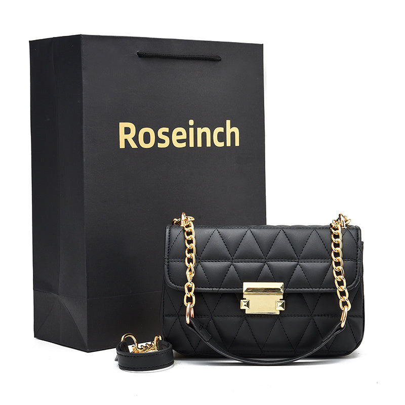 A black faux leather shoulder bag with a chain strap and a quilted pattern, displayed next to a matching black gift bag with 'Roseinch' branding.