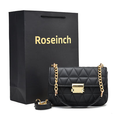 A black faux leather shoulder bag with a chain strap and a quilted pattern, displayed next to a matching black gift bag with 'Roseinch' branding.