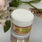 An advertisement image showing a container of KAPOMI body slimming cream with a yellow label. In the background, a person is measuring their waist with a measuring tape.