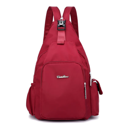 A red nylon backpack with a front pocket and side pockets, featuring a single shoulder strap and a telescopic handle.