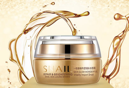 Skincare cream jar with snail theme on a gold and cream background.