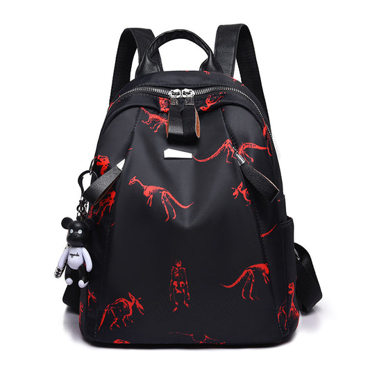 A black backpack with a red animal print and multiple compartments, including a top handle, front zipper pocket, and side mesh pockets.