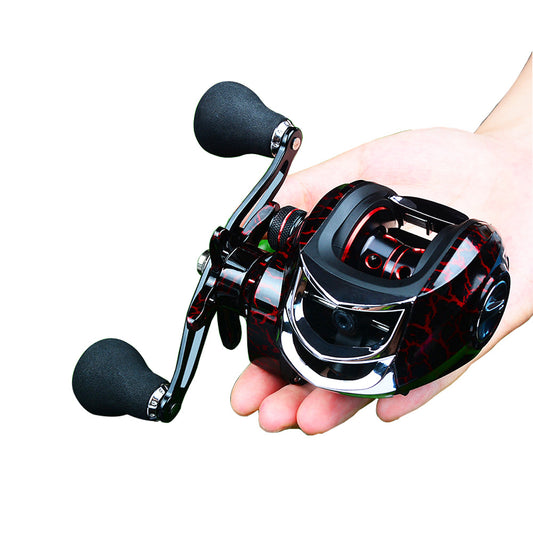 A hand holding a baitcasting fishing reel with a black and red color scheme.