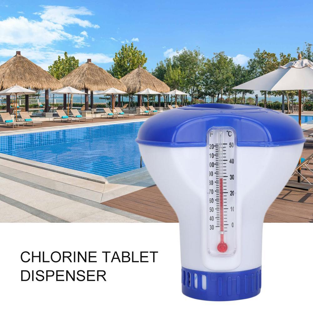 A floating chlorine tablet dispenser with a blue lid and a white body, placed in a pool setting.