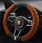 A red plush steering wheel cover with a black interior ring, designed for a vehicle's steering wheel.