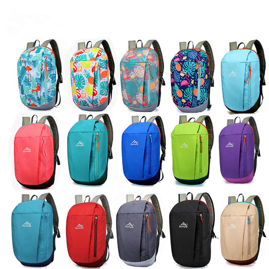 A collection of small backpacks in various solid colors and with outdoor-themed patterns.