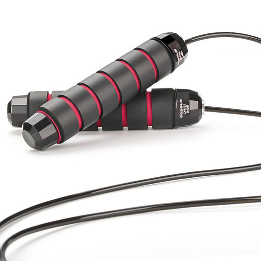 A black and red striped jump rope with foam handles and a steel wire rope, designed for fitness exercises.