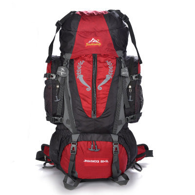 A large red and black outdoor backpack with multiple compartments and adjustable shoulder straps, designed for mountaineering and outdoor activities.