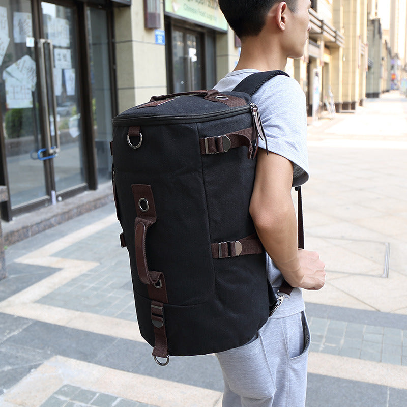 Person carrying a large black backpack on a city street