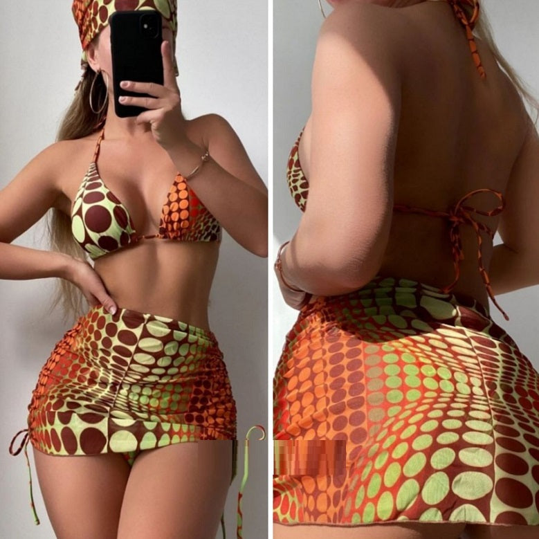 The image features a vibrant, geometric patterned split bikini swimsuit in shades of orange and yellow. The swimsuit includes a halter neck top with a deep split design and matching shorts that provide a stylish and flattering fit.
