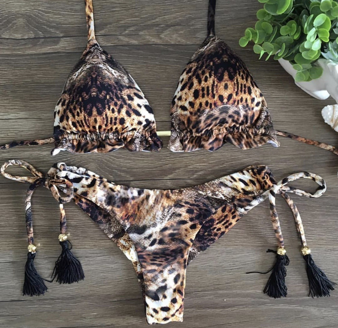 A two-piece bikini with a leopard print design, featuring a split design and tassel details.