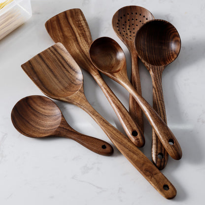 Set of wooden cooking utensils on a marble surface