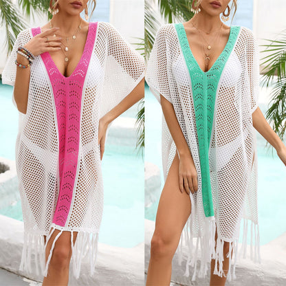 Two models wearing white beach blouses with tassels, one in green and one in rose red, standing by the beach.
