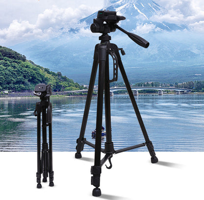 A black camera tripod extended to full height, set on a body of water with a mountain in the background, alongside a collapsed view of the tripod.