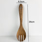 Wooden spatula with measurements on a white background
