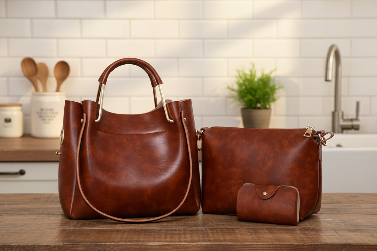 A set of three brown handbags including a tote bag, a shoulder bag, and a small purse, all with a vintage design.
