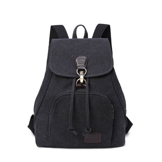A black canvas rucksack with a front pocket and a draw buckle, featuring a solid pattern and a bucket shape.