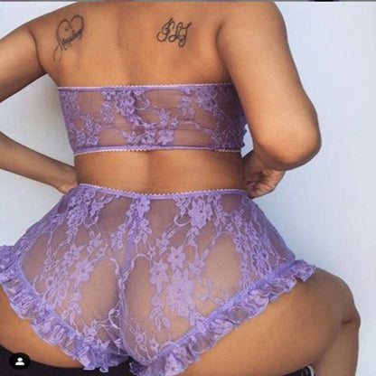 Rear view of a person wearing a purple lace lingerie set, including a strapless top and shorts.
