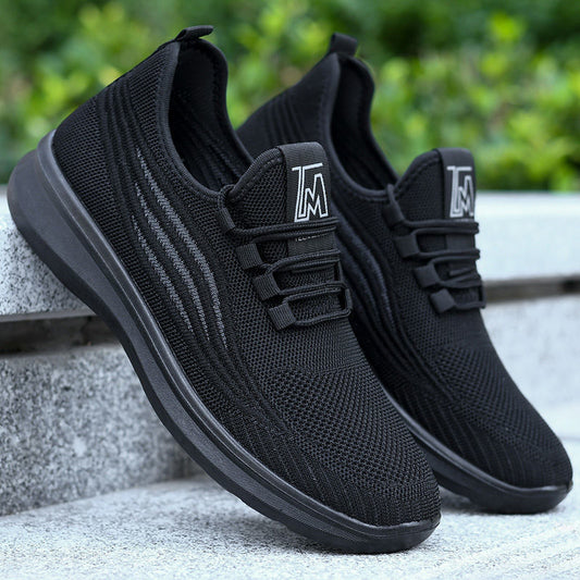 A pair of men's black chef antiskid shoes with a breathable sports design, featuring a round toe style, cloth lining, and a non-slip sole.