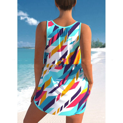 Person wearing a colorful geometric-patterned swimsuit on a beach.