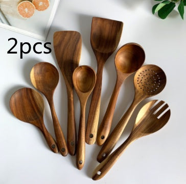 Set of wooden kitchen utensils on a white background