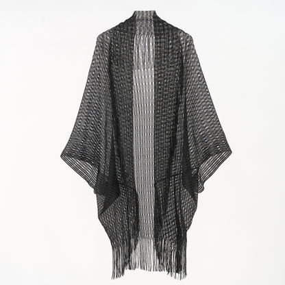 Black and white poncho with fringe on a white background