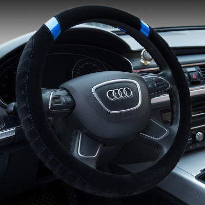 A black steering wheel cover with blue accents installed on a vehicle's steering wheel.
