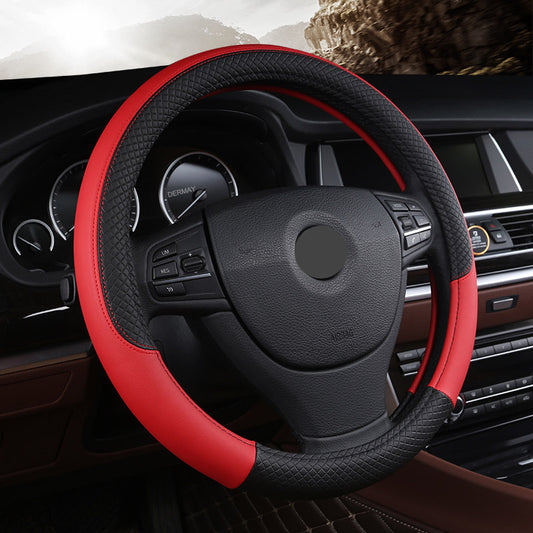 A red and black leather steering wheel cover installed on a car's steering wheel.