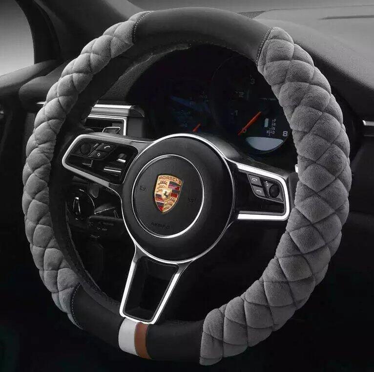 A red plush steering wheel cover with a black interior ring, designed for a vehicle's steering wheel.