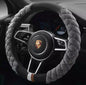 A red plush steering wheel cover with a black interior ring, designed for a vehicle's steering wheel.