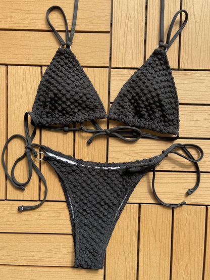 Black bikini set on a wooden surface