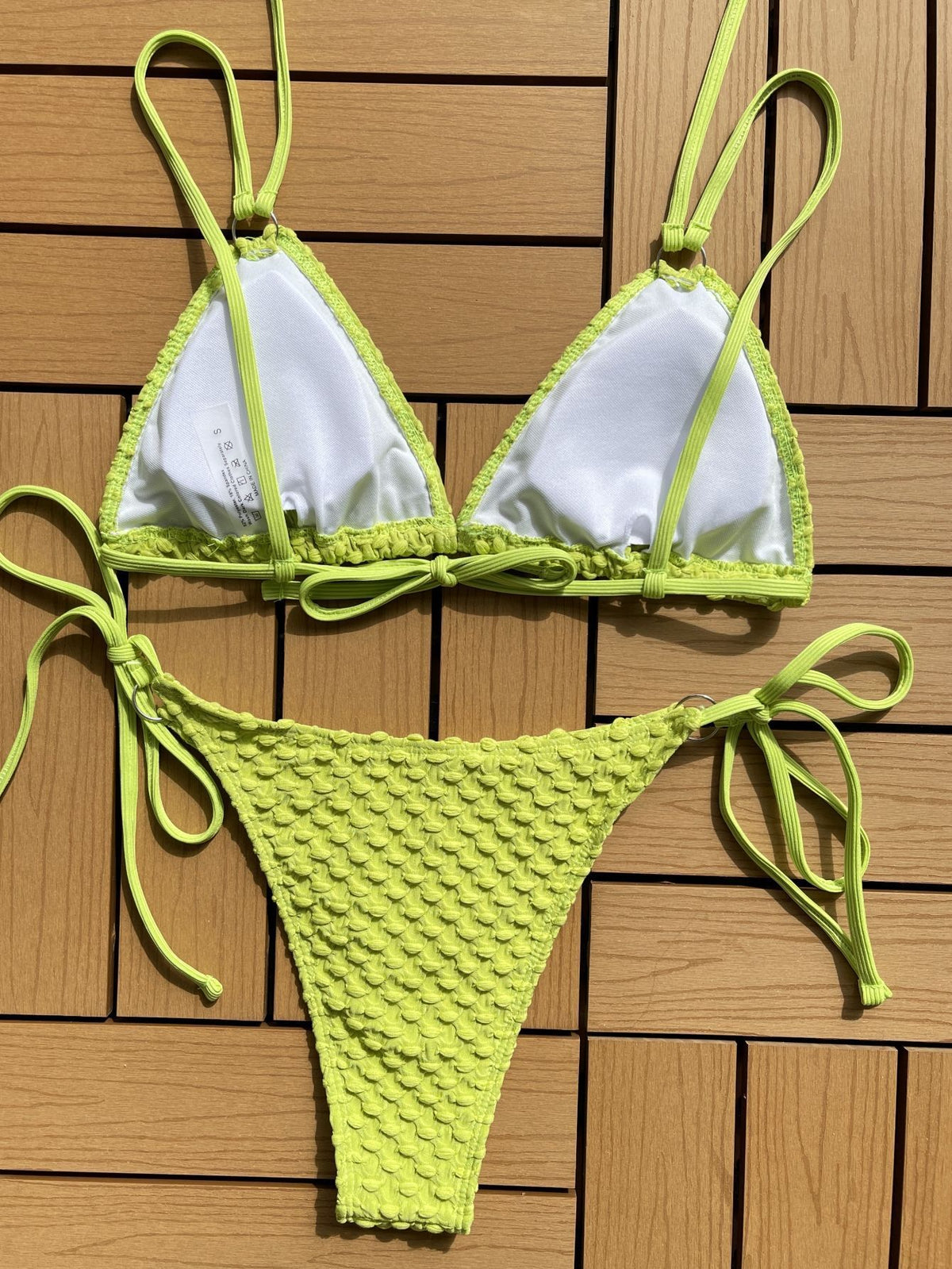 Yellow bikini set on a wooden background