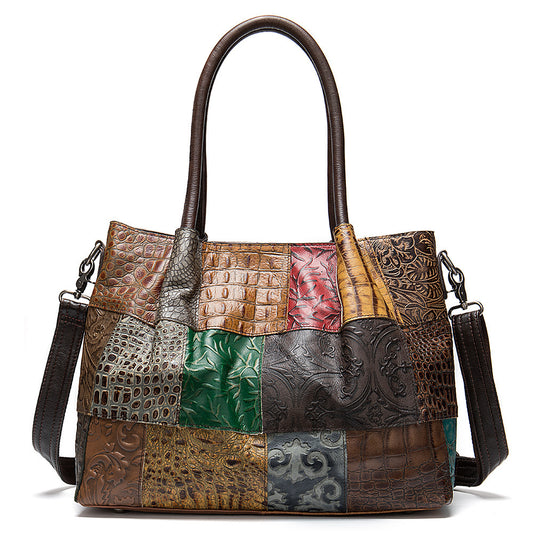 A multicolored leather handbag with embossed patterns, featuring a shoulder strap and a soft handle.